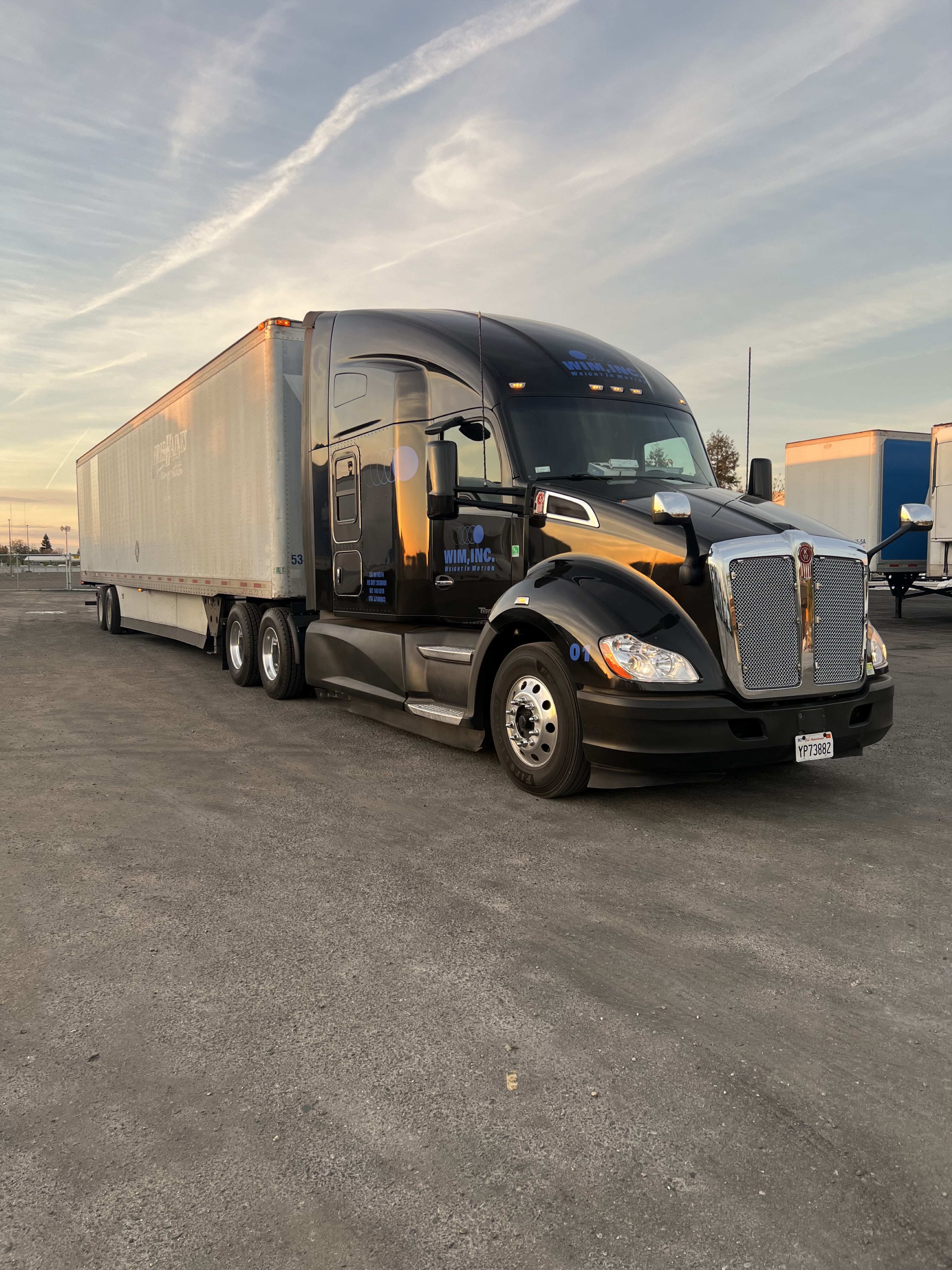 Truck in yard at sunset